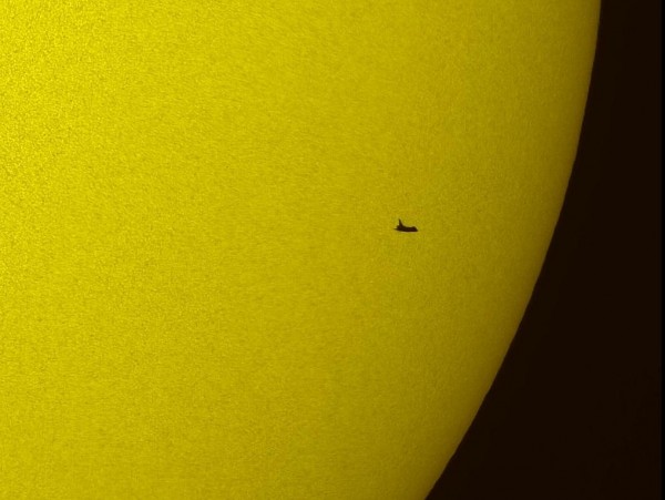 The Atlantis space shuttle transits the sun