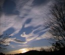 The clouds cast shadows across the sky