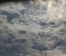 Cirrus clouds that are iridescent or nacreous