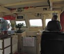 View of the captain and the bridge of the bum boat