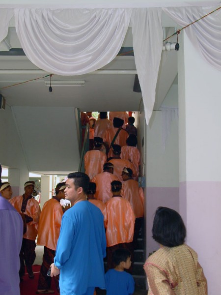 Wedding musicians began their walk up the steps from the void deck